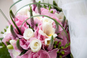 Beautiful wedding bouquet lying on top of the veil